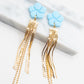 Oorbellen blauw goud bloem statement